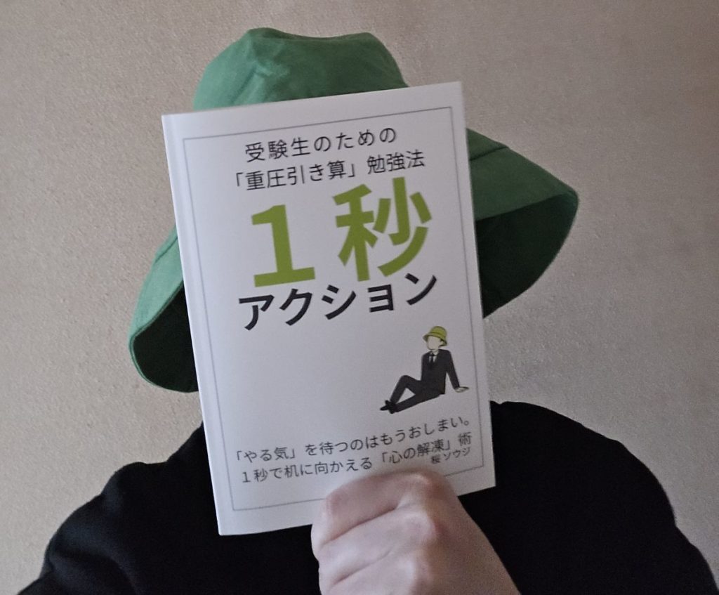 自著『1秒アクション』を手に持っている著者・桜ソウジ